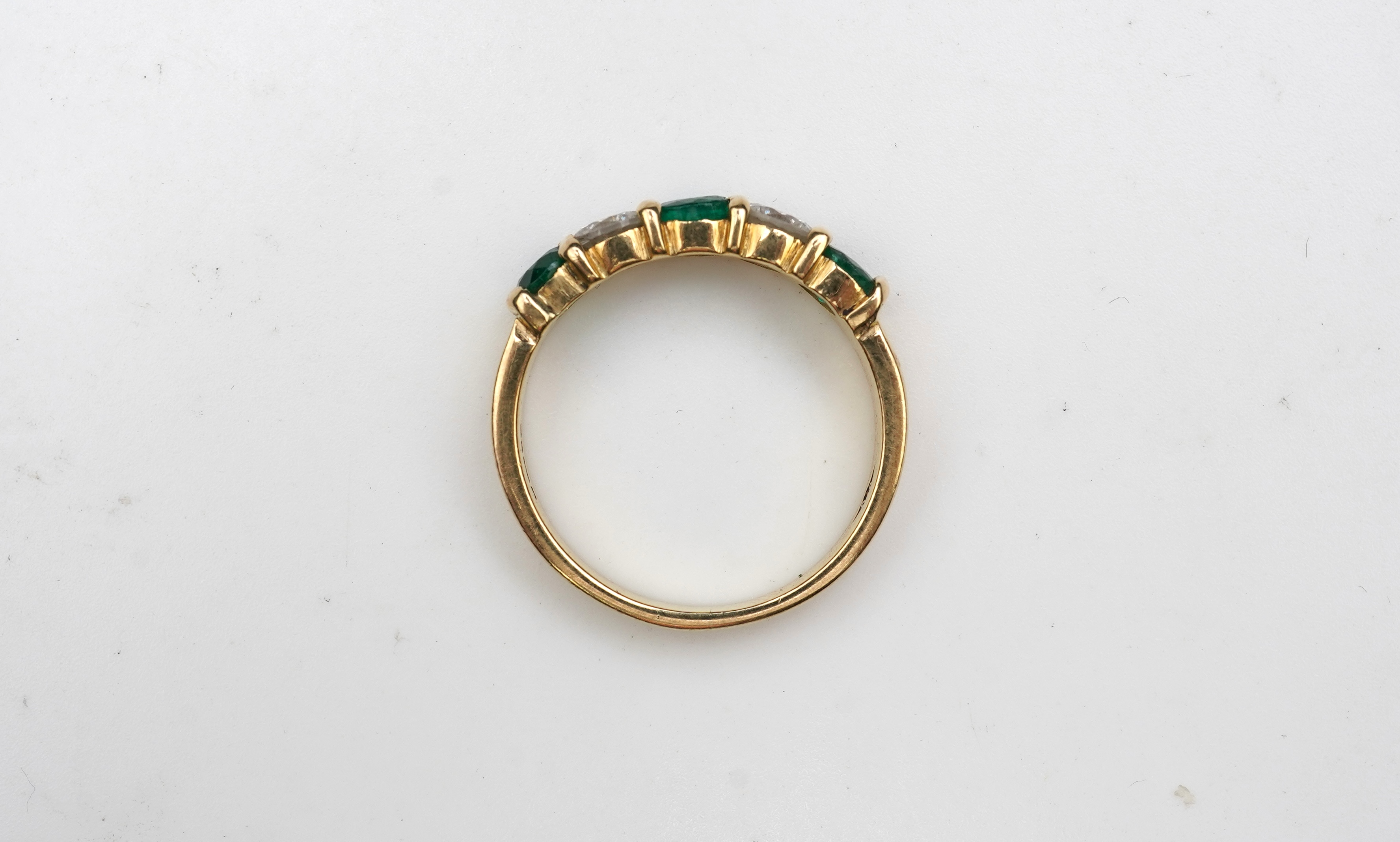 An emerald and diamond five-stone ring